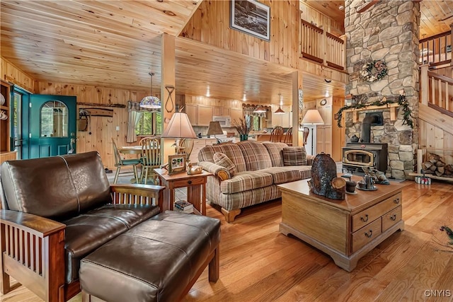 12103 Kincaid Rd, Forestport, NY 13338 - living room with wooden walls, wooden ceiling, wood finished floors, a wood stove, and high vaulted ceiling
