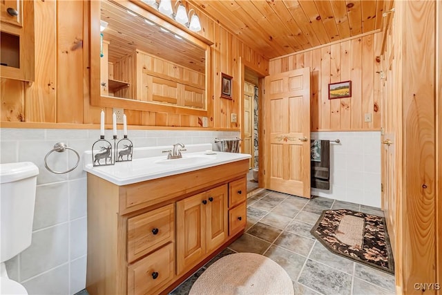 12103 Kincaid Rd, Forestport, NY 13338 - bathroom with vanity, toilet, wooden walls, and wood ceiling