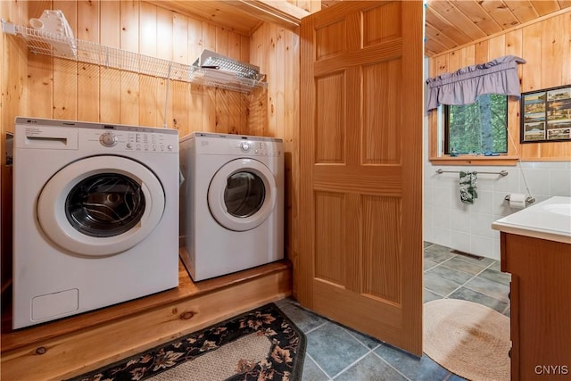 12103 Kincaid Rd, Forestport, NY 13338 - washroom with wooden walls, washer and clothes dryer, wooden ceiling, and tile patterned flooring