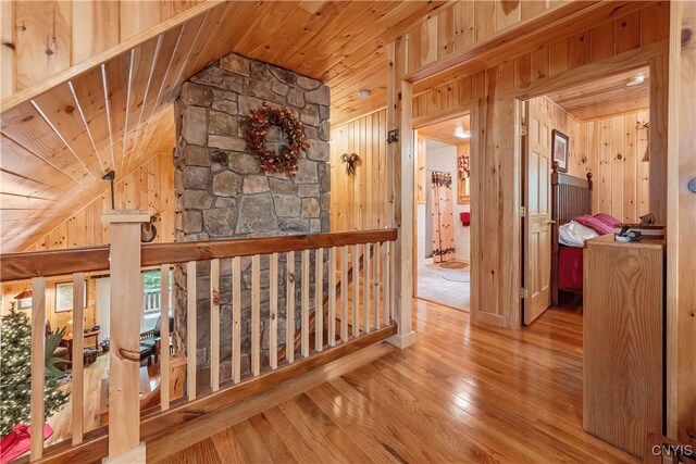 12103 Kincaid Rd, Forestport, NY 13338 - hall featuring lofted ceiling, wood walls, wooden ceiling, and hardwood / wood-style flooring