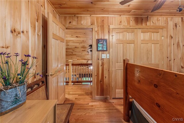 12103 Kincaid Rd, Forestport, NY 13338 - hallway with wood ceiling, wooden walls, and light wood-style flooring
