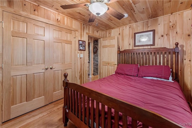 12103 Kincaid Rd, Forestport, NY 13338 - bedroom with wood ceiling, wooden walls, light wood finished floors, and a ceiling fan