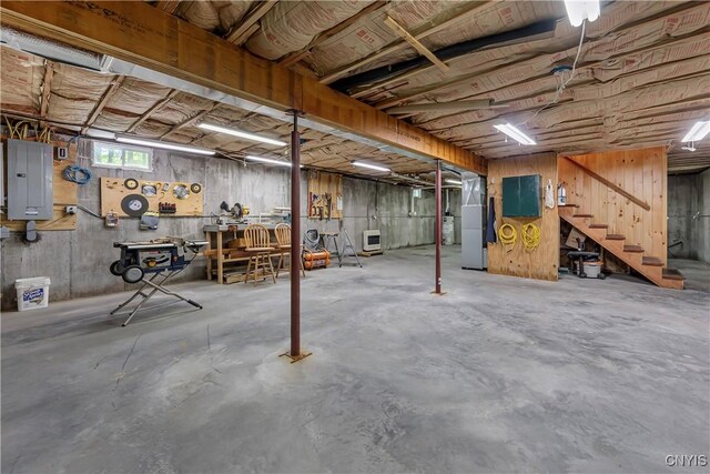 12103 Kincaid Rd, Forestport, NY 13338 - basement featuring electric panel, heating unit, and stairway