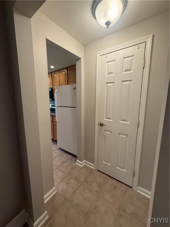 137 Watertree Dr, Dewitt, NY 13057 - hall with baseboards and light tile patterned floors