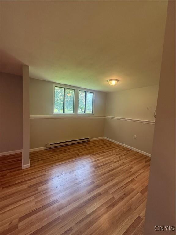 137 Watertree Dr, Dewitt, NY 13057 - empty room featuring a baseboard radiator, wood finished floors, and baseboards