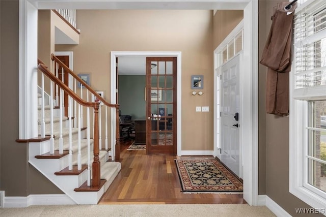 82 Arcadian Dr, Amherst, NY 14228 - foyer with baseboards, stairs, and wood finished floors