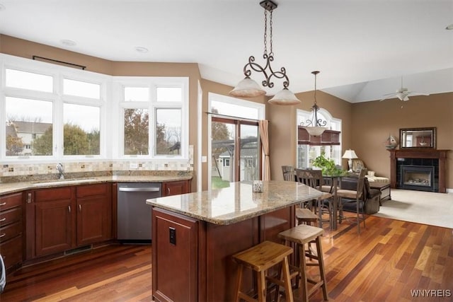 82 Arcadian Dr, Amherst, NY 14228 - kitchen featuring dishwasher, a sink, a fireplace, pendant lighting, and wood finished floors