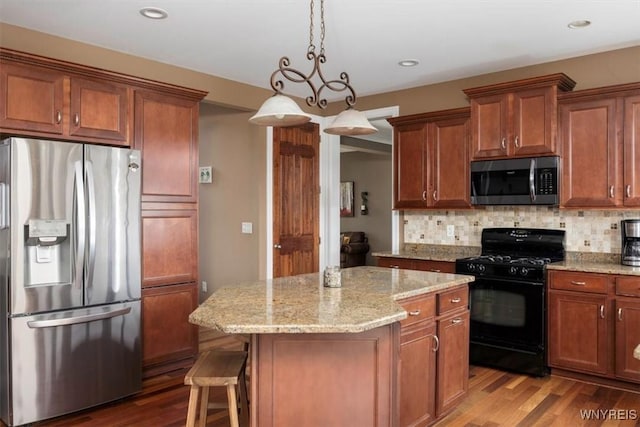 82 Arcadian Dr, Amherst, NY 14228 - kitchen featuring appliances with stainless steel finishes, wood finished floors, decorative backsplash, a center island, and light stone countertops
