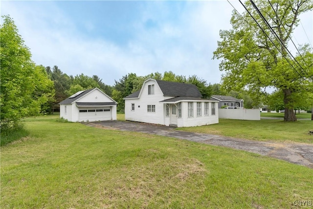 29580/584 Maple St Unit 584, Le Ray, NY 13612 - view of side of home with a garage, an outdoor structure, a yard, and roof with shingles