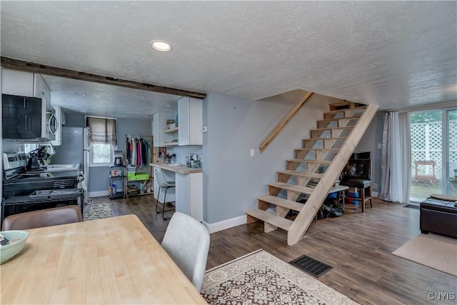 29580/584 Maple St Unit 584, Le Ray, NY 13612 - dining room with a textured ceiling, baseboards, stairs, and dark wood-style floors