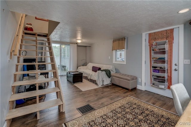 29580/584 Maple St Unit 584, Le Ray, NY 13612 - bedroom featuring a textured ceiling, wood finished floors, and baseboards