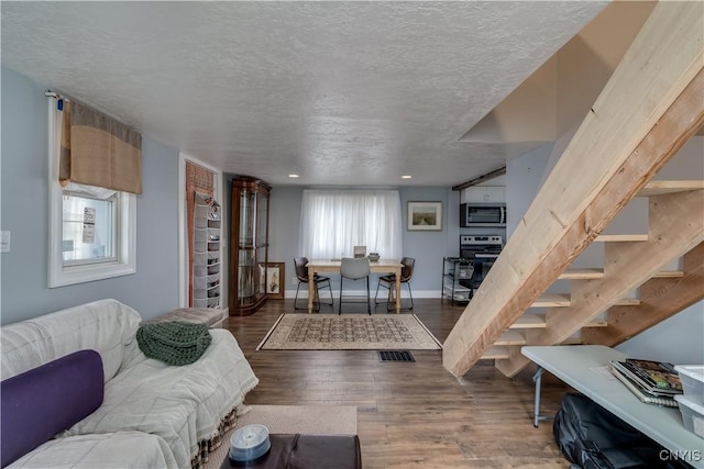 29580/584 Maple St Unit 584, Le Ray, NY 13612 - living room with wood finished floors, stairway, a textured ceiling, baseboards, and recessed lighting