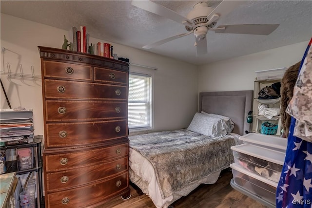 29580/584 Maple St Unit 584, Le Ray, NY 13612 - bedroom featuring dark wood-style floors, a ceiling fan, and a textured ceiling