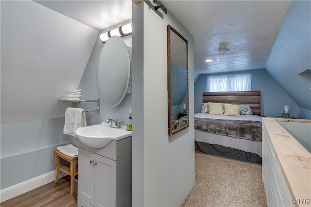29580/584 Maple St Unit 584, Le Ray, NY 13612 - ensuite bathroom with vanity, lofted ceiling, and baseboards