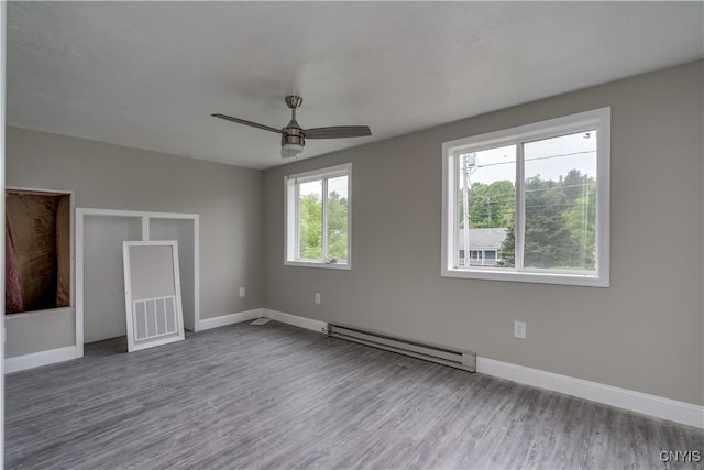 29580/584 Maple St Unit 584, Le Ray, NY 13612 - unfurnished bedroom with a baseboard heating unit, wood finished floors, baseboards, and ceiling fan