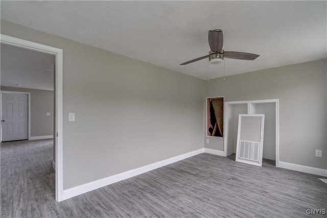 29580/584 Maple St Unit 584, Le Ray, NY 13612 - empty room featuring wood finished floors, a ceiling fan, and baseboards