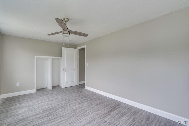 29580/584 Maple St Unit 584, Le Ray, NY 13612 - unfurnished bedroom with baseboards, wood finished floors, a closet, and a ceiling fan