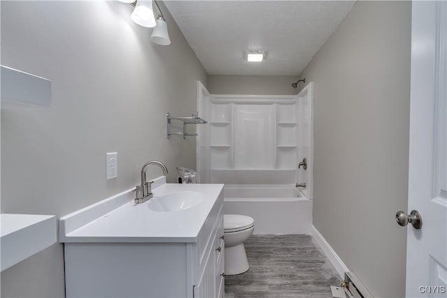 29580/584 Maple St Unit 584, Le Ray, NY 13612 - full bathroom with toilet, vanity, wood finished floors, shower / bathtub combination, and a baseboard radiator