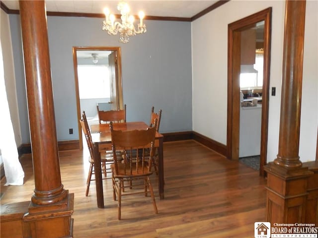 123 N Dow St, Ellicott, NY 14733 - dining space with decorative columns, crown molding, wood finished floors, baseboards, and a chandelier