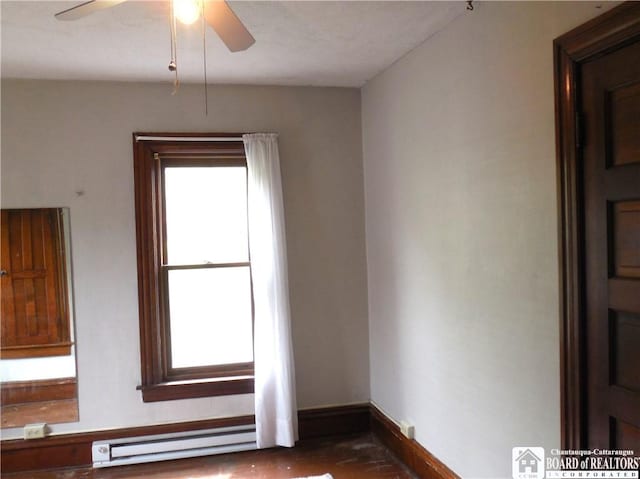 123 N Dow St, Ellicott, NY 14733 - empty room featuring baseboard heating, ceiling fan, and baseboards