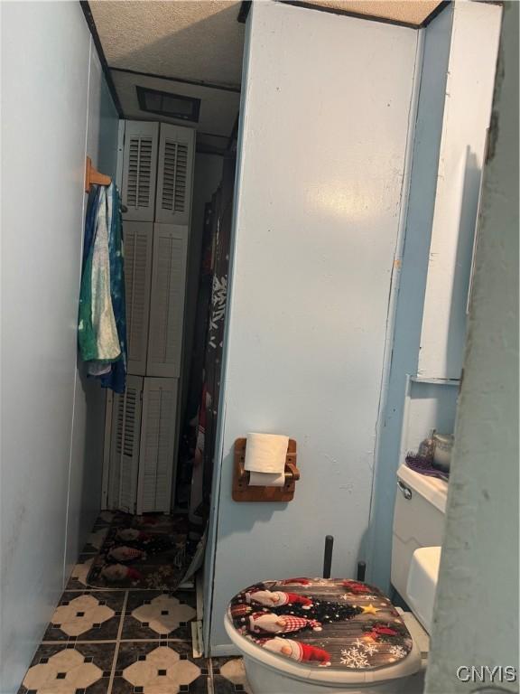 403 Coffeen St, Watertown-City, NY 13601 - bathroom with toilet and tile patterned floors