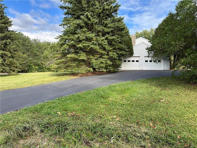 1840 Watson Cir, Tully, NY 13159 - view of front of house featuring a front lawn, a detached garage, and a chimney