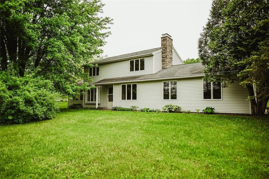 1840 Watson Cir, Tully, NY 13159 - back of property featuring a chimney and a lawn