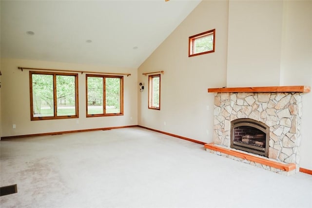 1840 Watson Cir, Tully, NY 13159 - unfurnished living room featuring carpet flooring, high vaulted ceiling, baseboards, a stone fireplace, and plenty of natural light