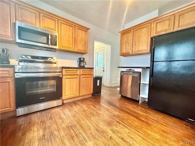 171 Maplehurst Ave, Syracuse, NY 13208 - kitchen featuring stainless steel appliances, light wood-type flooring, brown cabinetry, and a textured ceiling