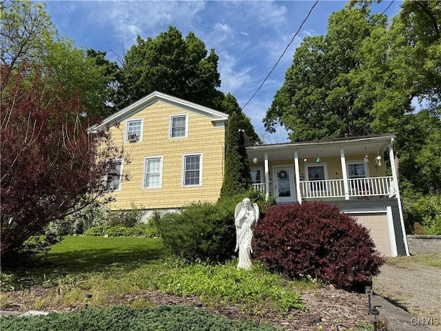 58 S Hamilton St, Elbridge, NY 13080 - view of front of house featuring a garage, a porch, and a front yard