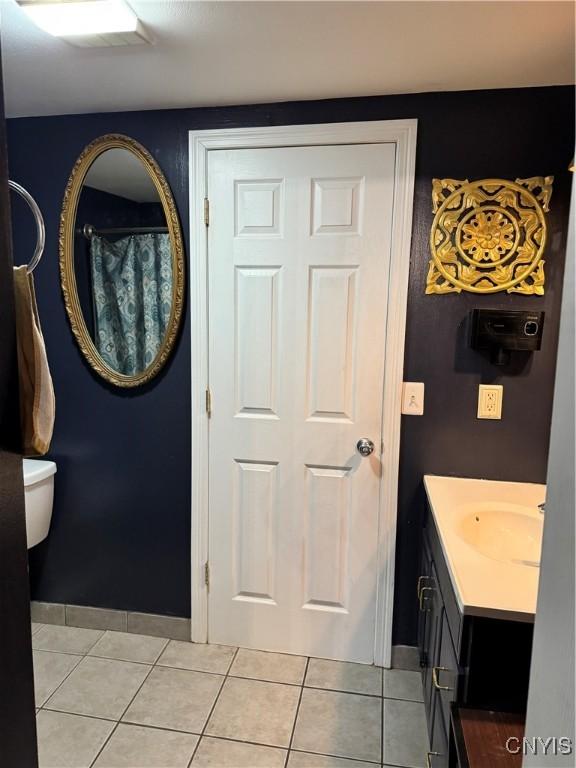 58 S Hamilton St, Elbridge, NY 13080 - full bathroom with vanity, tile patterned flooring, baseboards, and toilet