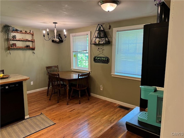 58 S Hamilton St, Elbridge, NY 13080 - dining area with a chandelier, wood finished floors, and baseboards