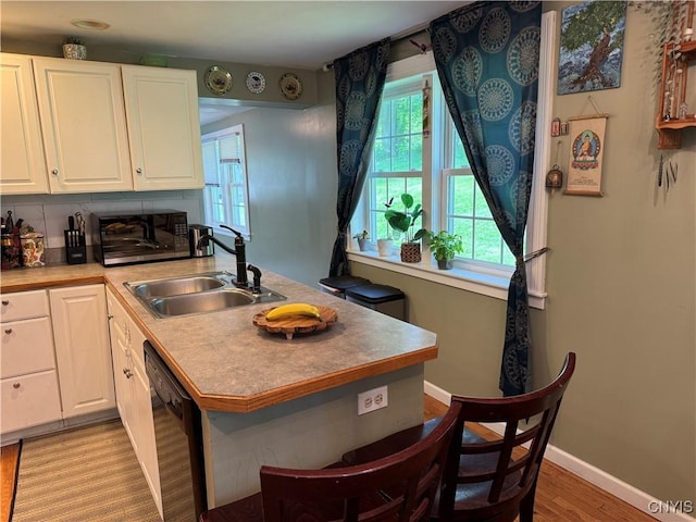 58 S Hamilton St, Elbridge, NY 13080 - kitchen with a sink, black appliances, white cabinets, and a peninsula