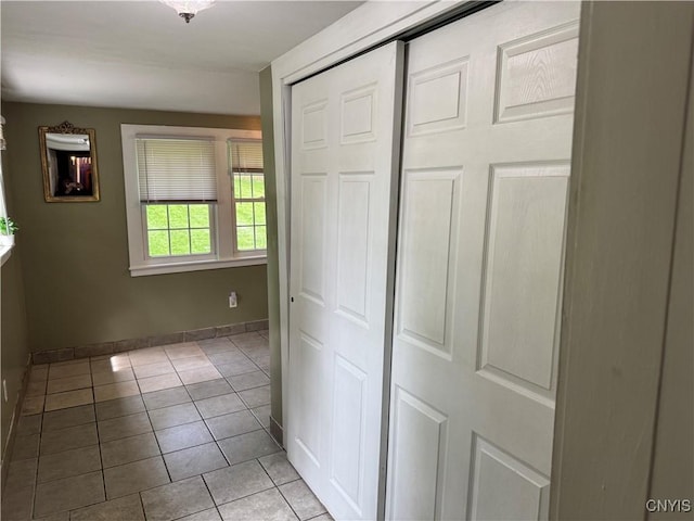 58 S Hamilton St, Elbridge, NY 13080 - unfurnished bedroom with tile patterned flooring, a closet, and baseboards