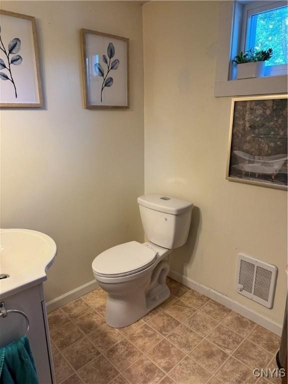 58 S Hamilton St, Elbridge, NY 13080 - half bath with baseboards, vanity, and toilet