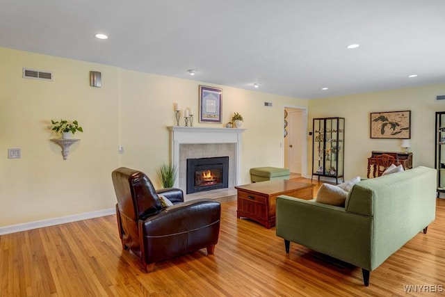 515 Park Club Ln, Amherst, NY 14221 - living area with light wood-type flooring, a tile fireplace, recessed lighting, and baseboards