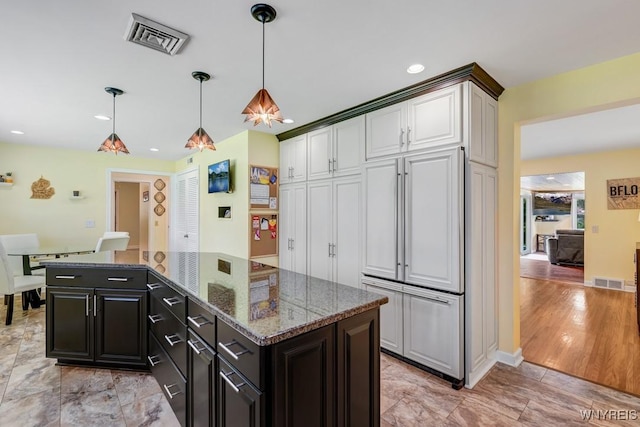 515 Park Club Ln, Amherst, NY 14221 - kitchen featuring hanging light fixtures, a kitchen island, dark stone countertops, dark cabinets, and recessed lighting