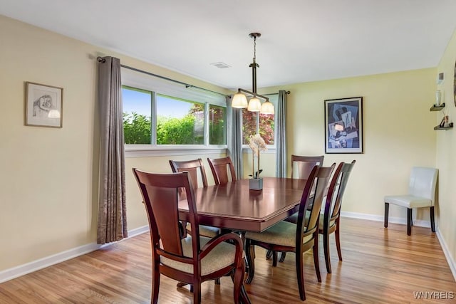 515 Park Club Ln, Amherst, NY 14221 - dining room with baseboards, light wood-type flooring, and a chandelier