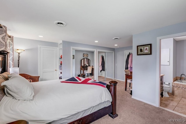 515 Park Club Ln, Amherst, NY 14221 - carpeted bedroom featuring multiple closets, recessed lighting, baseboards, and ensuite bathroom