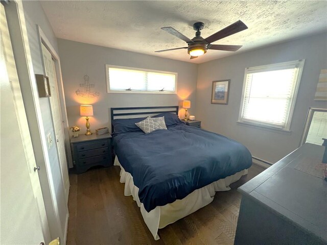 5545 E Lake Rd, Conesus, NY 14435 - bedroom with wood finished floors, multiple windows, a baseboard radiator, a textured ceiling, and ceiling fan