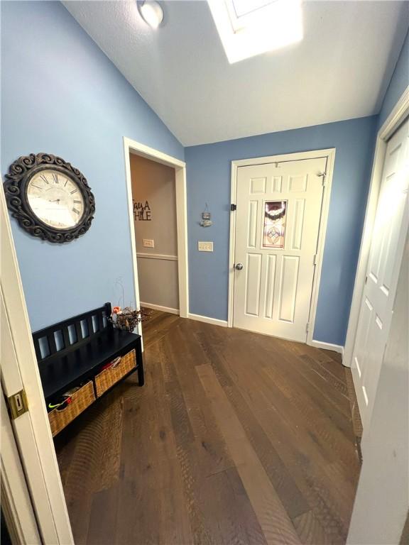 5545 E Lake Rd, Conesus, NY 14435 - entrance foyer with lofted ceiling, dark wood-style floors, and baseboards