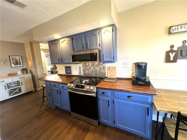 5545 E Lake Rd, Conesus, NY 14435 - kitchen with stainless steel appliances, a textured ceiling, wooden counters, dark wood-type flooring, and decorative backsplash