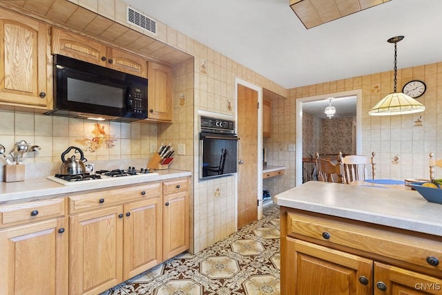 4922 Tenterden Dr, Onondaga, NY 13215 - kitchen with black appliances, tile walls, light countertops, decorative light fixtures, and backsplash