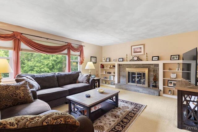 4922 Tenterden Dr, Onondaga, NY 13215 - living room featuring healthy amount of natural light, carpet flooring, and a glass covered fireplace