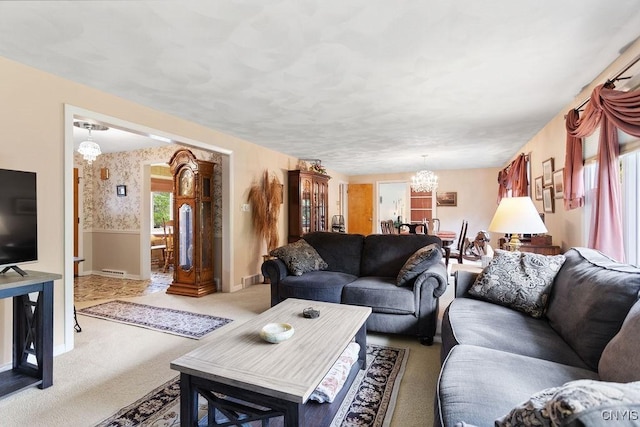 4922 Tenterden Dr, Onondaga, NY 13215 - carpeted living room with a chandelier, baseboards, and wallpapered walls
