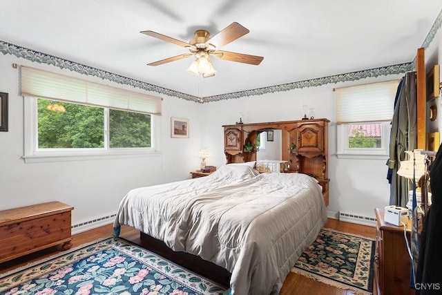 4922 Tenterden Dr, Onondaga, NY 13215 - bedroom with a baseboard radiator, wood finished floors, ceiling fan, and baseboards