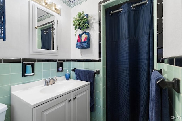 4922 Tenterden Dr, Onondaga, NY 13215 - bathroom with vanity, tile walls, toilet, a shower with curtain, and wainscoting