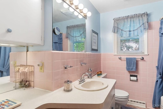 4922 Tenterden Dr, Onondaga, NY 13215 - full bathroom with toilet, a baseboard heating unit, vanity, and tile walls