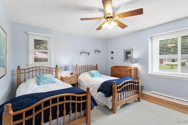4922 Tenterden Dr, Onondaga, NY 13215 - bedroom with baseboard heating, wood finished floors, baseboards, and ceiling fan
