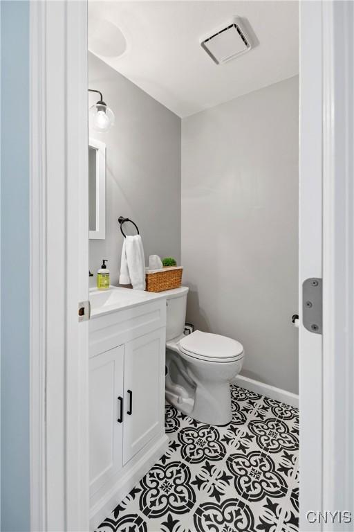 8005 Fir Dr, Clay, NY 13041 - bathroom featuring vanity, toilet, and tile patterned floors